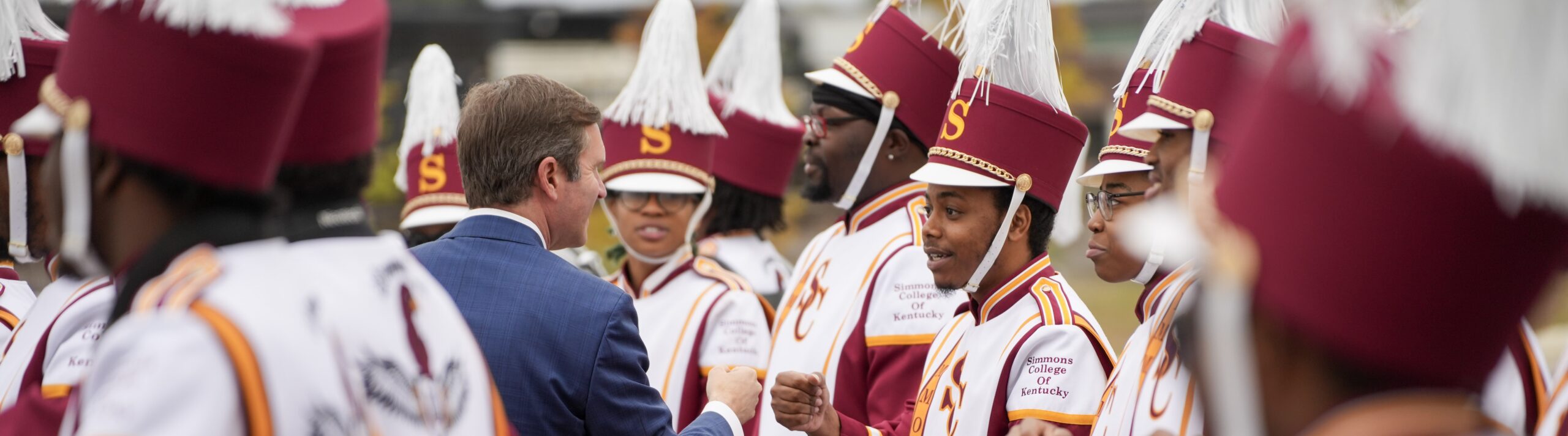Image of Gov. Beshear with Simmons College of Kentucky marching band.